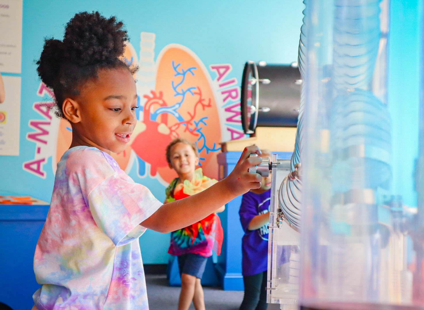 Two small children are playing inside a pretend spaceship