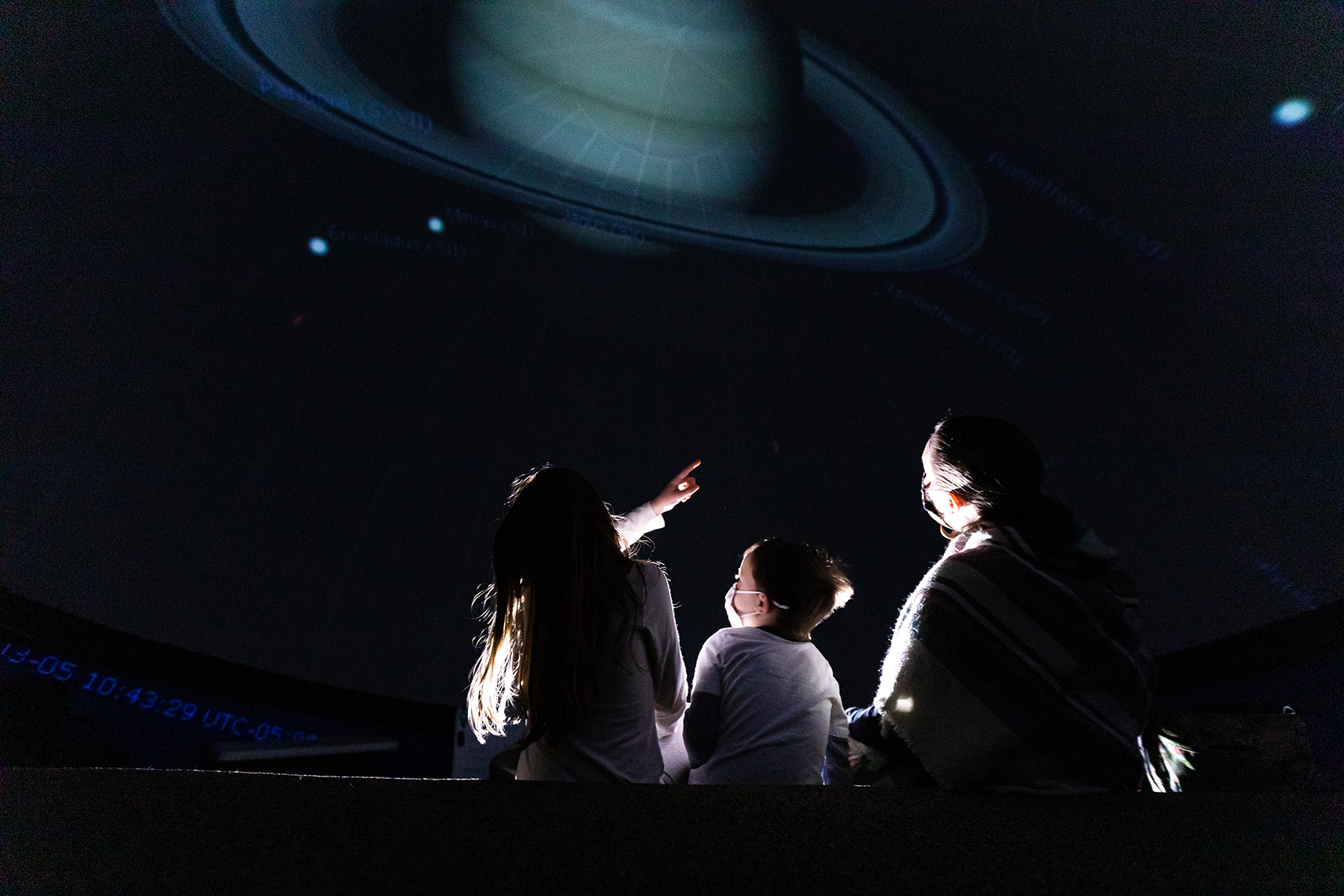 Two small children are playing inside a pretend spaceship